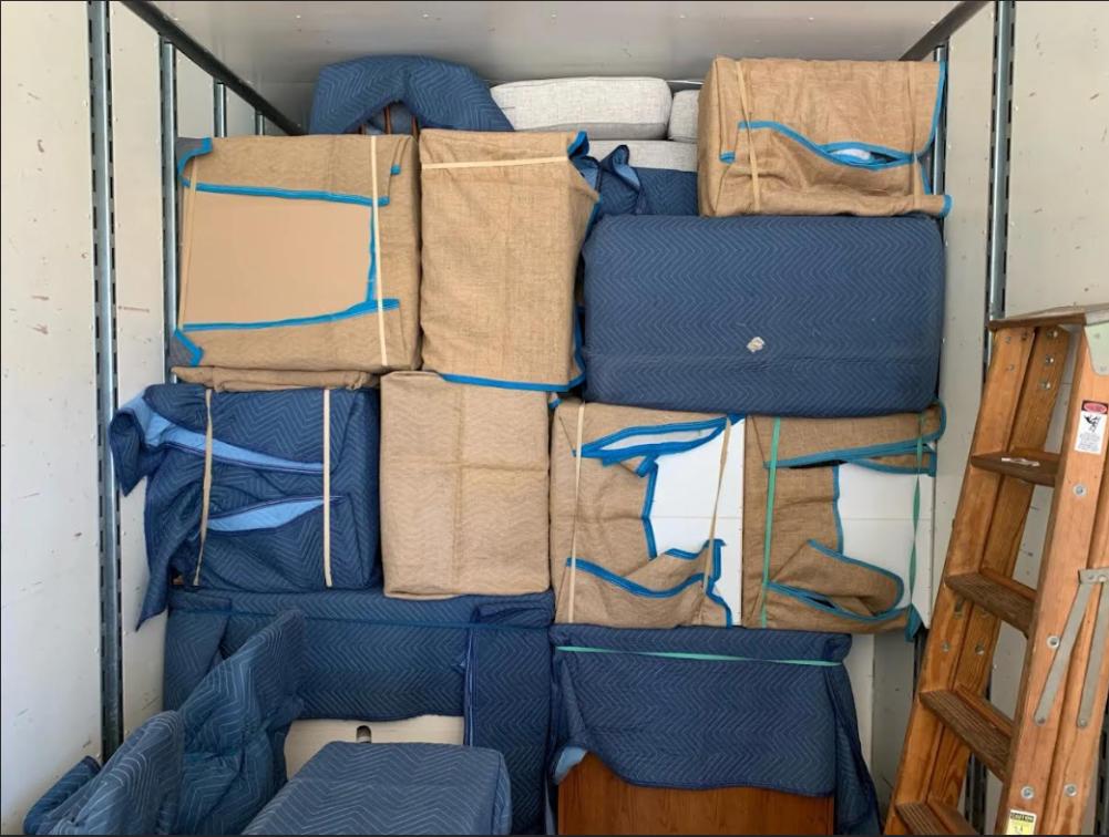 Professional movers preparing a home for a long-distance relocation